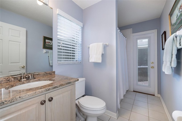 bathroom with vanity, toilet, and tile patterned flooring