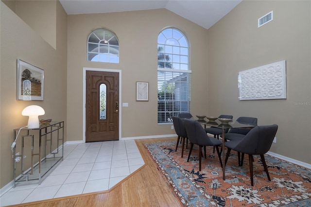 foyer featuring high vaulted ceiling and light hardwood / wood-style flooring