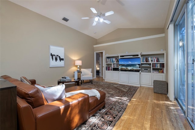 living room featuring hardwood / wood-style flooring, ceiling fan, and lofted ceiling