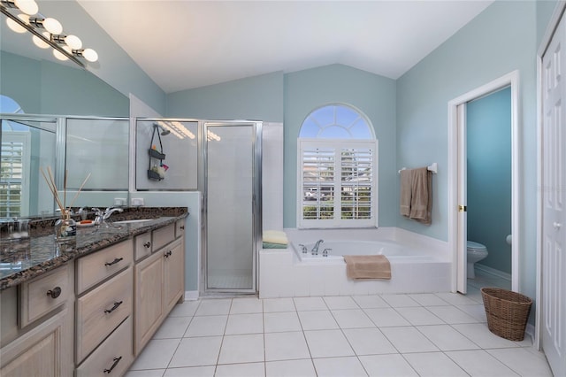 full bathroom featuring vaulted ceiling, shower with separate bathtub, tile patterned flooring, vanity, and toilet