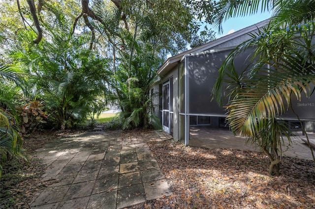 exterior space with a sunroom and a patio area