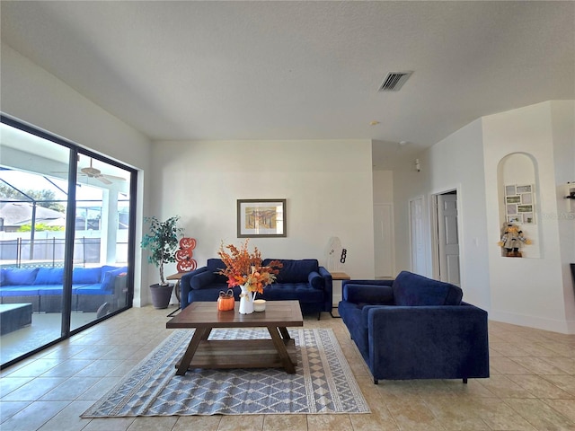 living room with ceiling fan and light tile patterned flooring