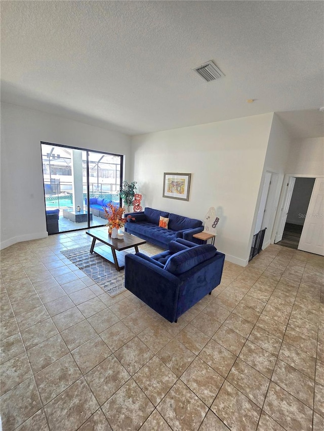 living room with light tile patterned floors and a textured ceiling