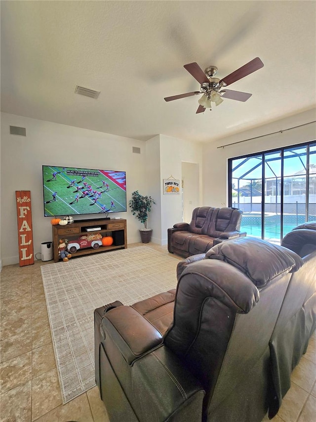 living room with ceiling fan and light tile patterned floors