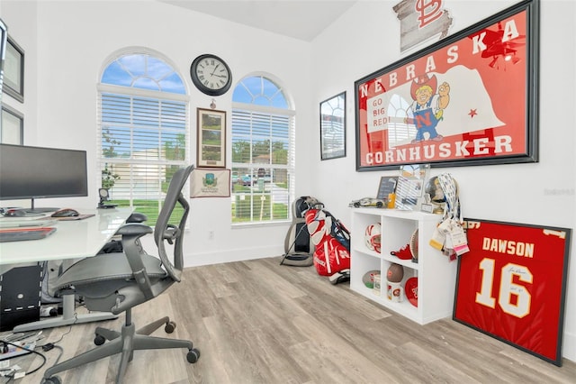 home office with light hardwood / wood-style flooring