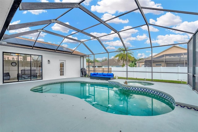 view of swimming pool featuring a patio area, an in ground hot tub, and glass enclosure