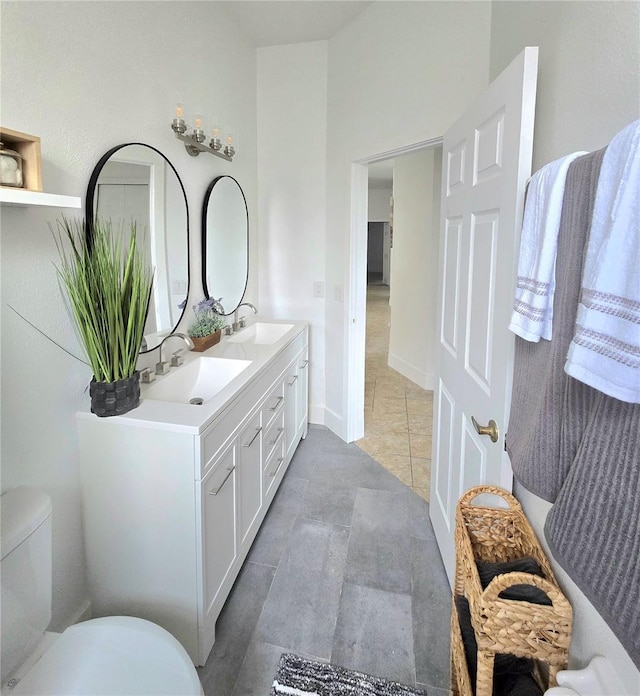 bathroom featuring tile patterned floors, vanity, and toilet