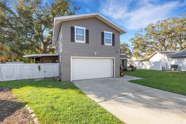 view of property with a garage, central air condition unit, and a front lawn