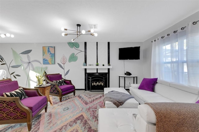 living room with a fireplace and an inviting chandelier