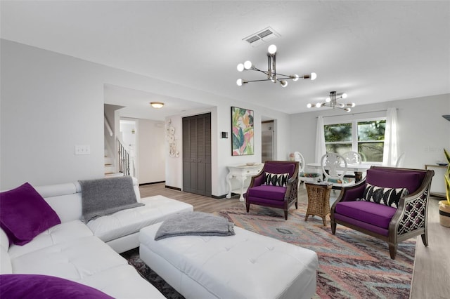 living room with hardwood / wood-style floors and a chandelier