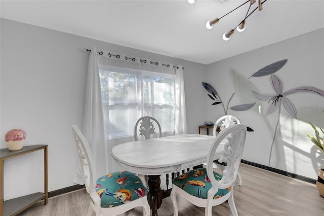 dining space featuring a notable chandelier and light hardwood / wood-style flooring