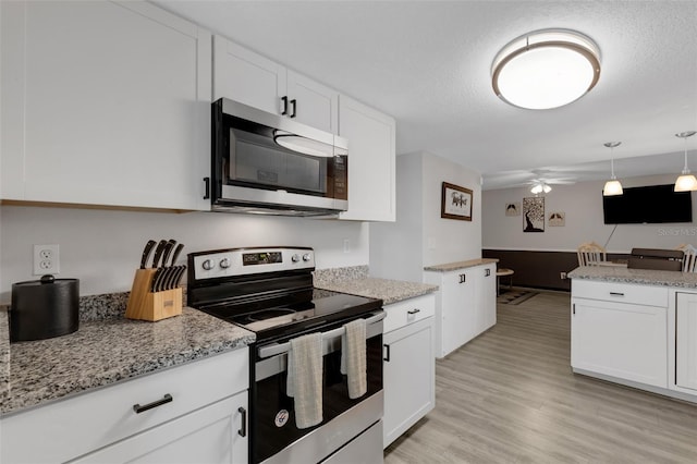 kitchen featuring white cabinets, appliances with stainless steel finishes, light wood-type flooring, and ceiling fan