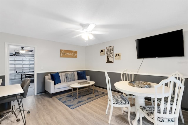 living room featuring ceiling fan and wood-type flooring