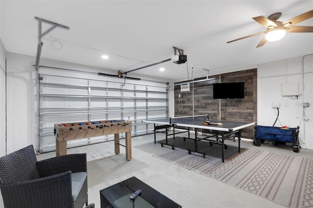 game room featuring ceiling fan and concrete floors