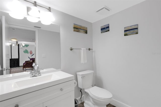 bathroom with vanity and toilet