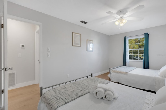 bedroom with ceiling fan and light wood-type flooring