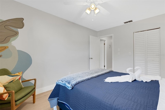 bedroom featuring ceiling fan, a closet, and wood-type flooring