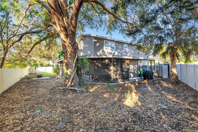 rear view of property with a sunroom