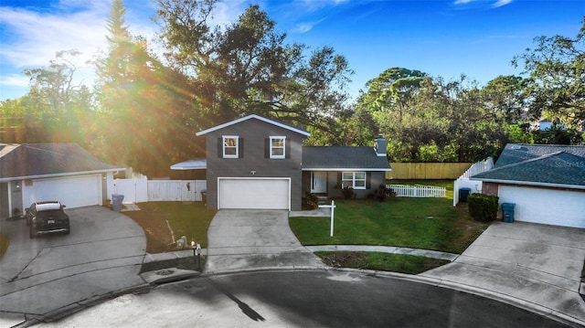 view of front of property featuring a garage and a front lawn