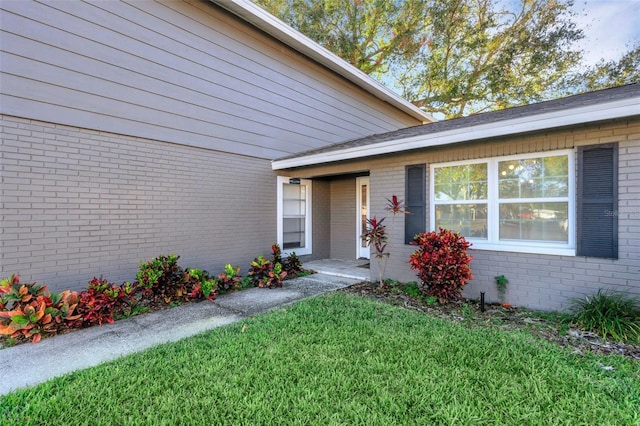 entrance to property with a yard