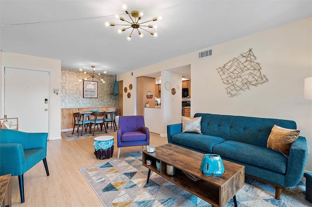 living room featuring an inviting chandelier and wood-type flooring