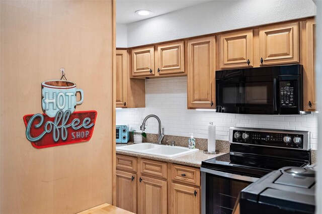 kitchen with electric range, tasteful backsplash, and sink