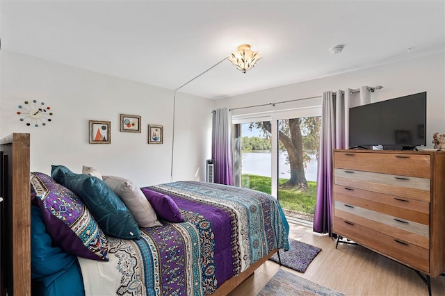 bedroom featuring light wood-type flooring and access to outside