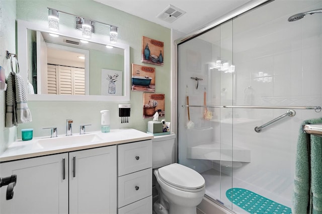 bathroom with walk in shower, toilet, and vanity