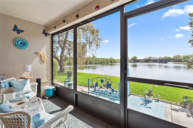 sunroom / solarium with a water view and plenty of natural light