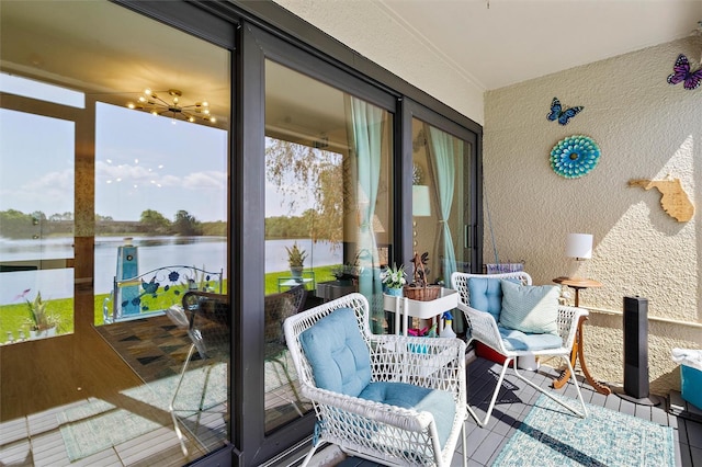 sunroom / solarium with a water view