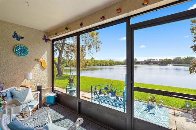 sunroom / solarium featuring a water view and a wealth of natural light