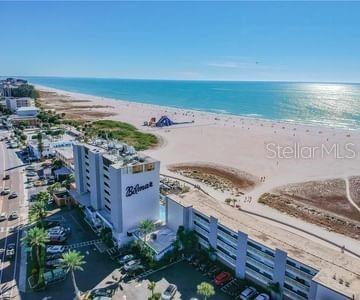 drone / aerial view featuring a beach view and a water view