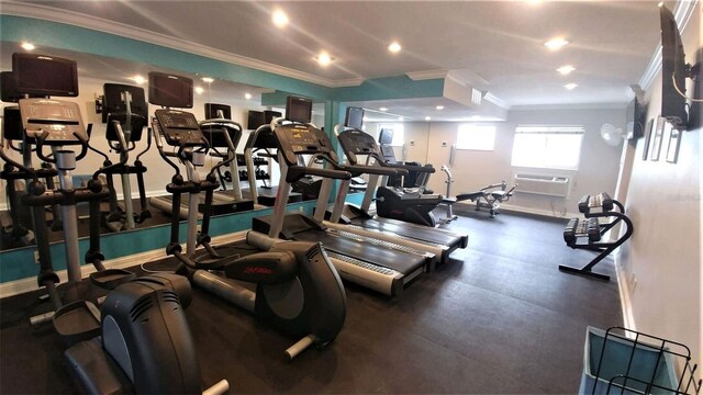 gym featuring a wall mounted AC and ornamental molding