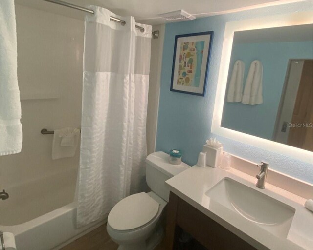 full bathroom featuring vanity, toilet, and shower / tub combo