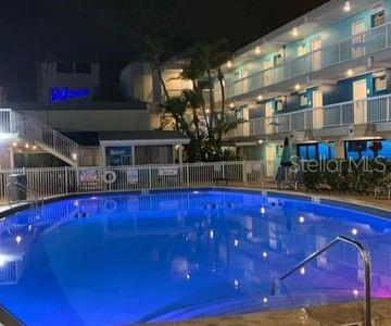 view of pool at twilight