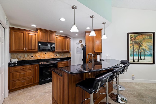 kitchen featuring kitchen peninsula, black appliances, a kitchen breakfast bar, light tile patterned floors, and decorative light fixtures