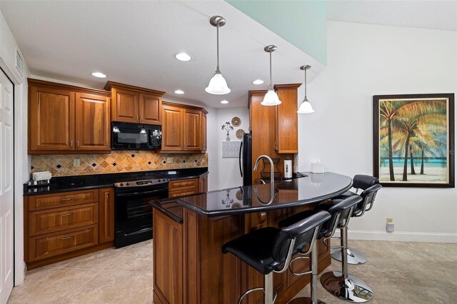 kitchen with brown cabinetry, a breakfast bar area, decorative light fixtures, black appliances, and backsplash