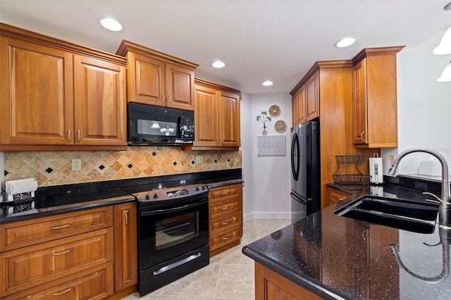 kitchen featuring decorative backsplash, light tile patterned flooring, sink, dark stone counters, and black appliances