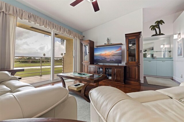 living area with lofted ceiling, dark wood-style floors, and ceiling fan