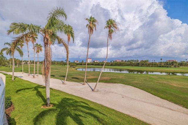 surrounding community with a lawn and a water view