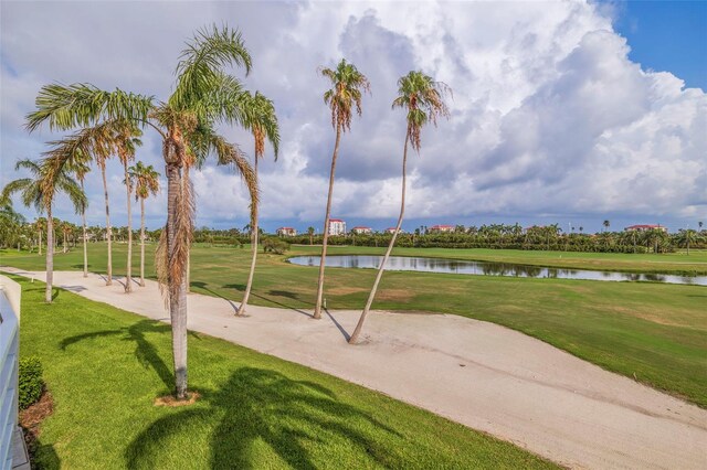 view of property's community featuring a yard, a water view, and volleyball court
