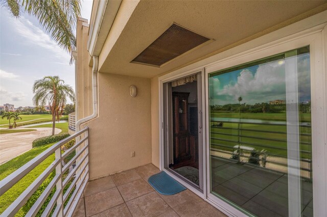 doorway to property featuring stucco siding