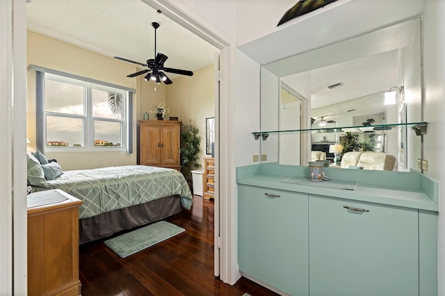 bedroom with ceiling fan and dark wood-type flooring