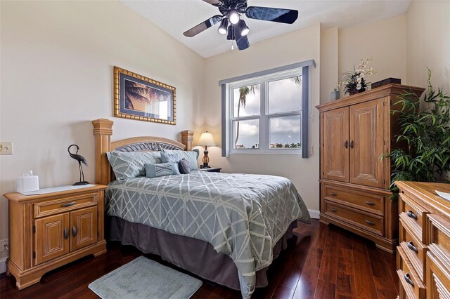 bedroom with dark wood-type flooring and a ceiling fan