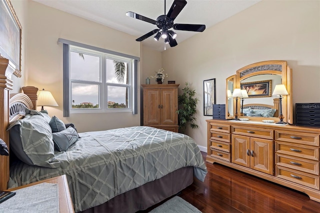 bedroom featuring ceiling fan and dark wood-type flooring