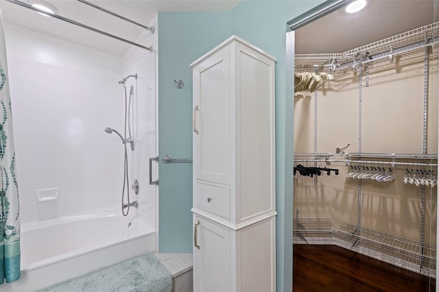 bathroom featuring bathtub / shower combination and hardwood / wood-style flooring