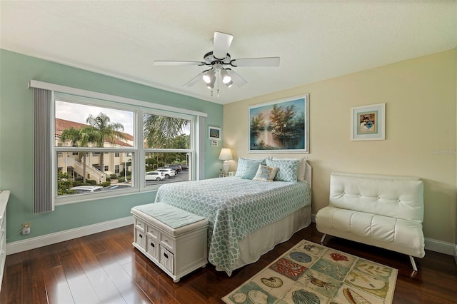 bedroom with ceiling fan and dark wood-type flooring