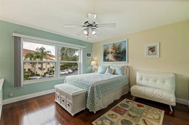 bedroom featuring ceiling fan, dark wood-type flooring, and baseboards