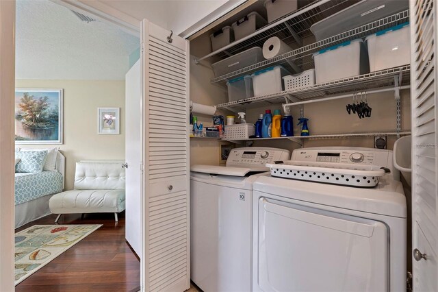 laundry area featuring laundry area, separate washer and dryer, and dark wood-style flooring
