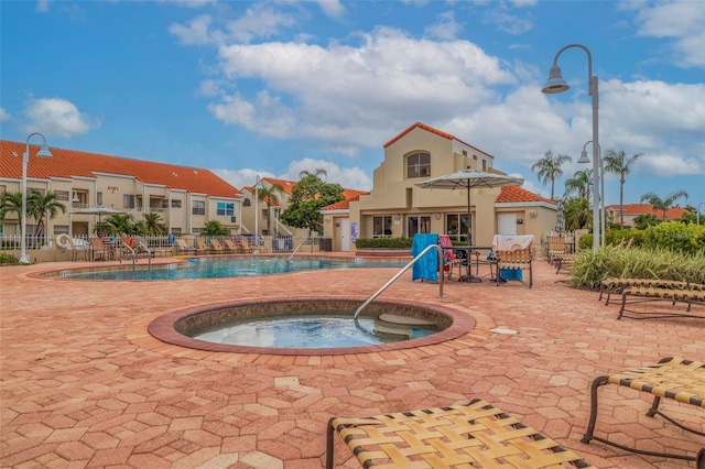 view of swimming pool with a community hot tub and a patio